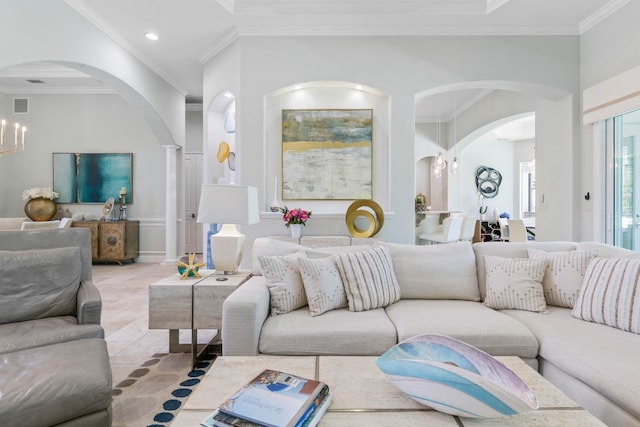 tiled living room with crown molding and a chandelier