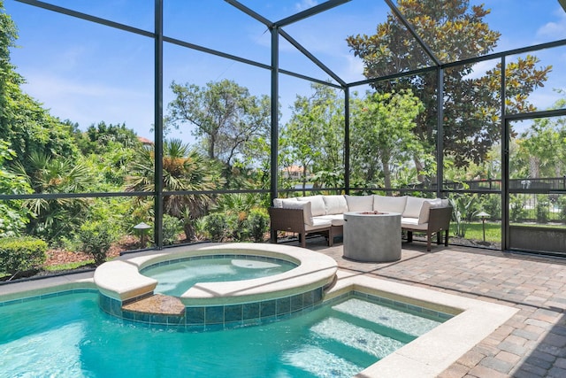 view of pool featuring an in ground hot tub, outdoor lounge area, a patio, and a lanai