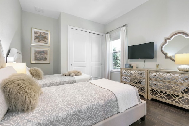 bedroom featuring dark hardwood / wood-style flooring and a closet