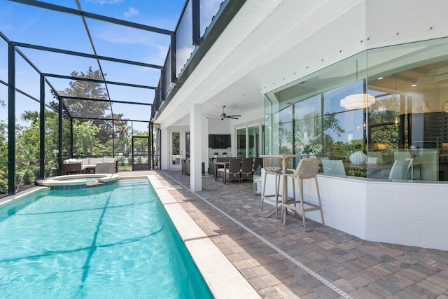 view of swimming pool featuring a patio, a bar, an in ground hot tub, ceiling fan, and glass enclosure