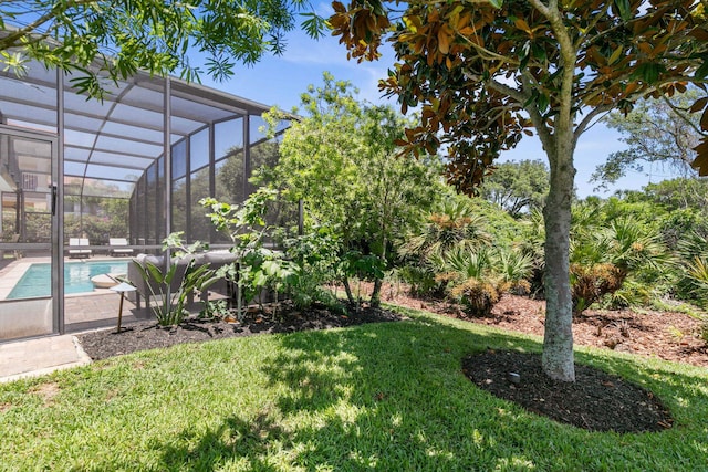 view of yard featuring glass enclosure