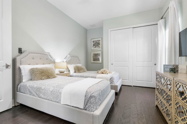 bedroom featuring dark hardwood / wood-style floors and a closet