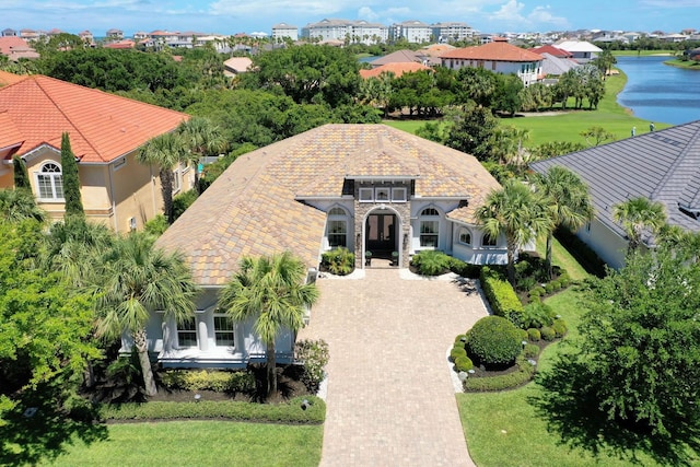 16 Hammock Beach Pkwy, Palm Coast, FL 32137 - mediterranean / spanish house with a water view, a tile roof, and stucco siding
