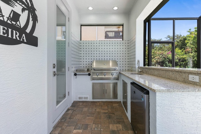 view of patio / terrace with exterior kitchen, sink, and grilling area