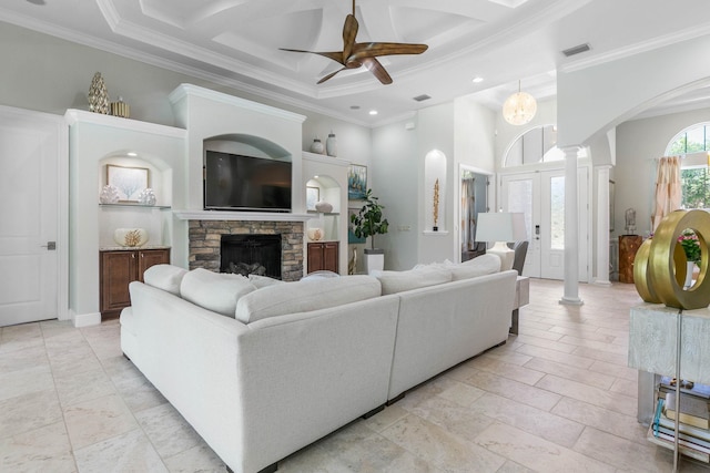 living room featuring ornamental molding, coffered ceiling, and decorative columns