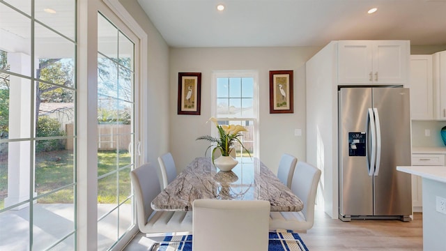 dining room featuring plenty of natural light and light hardwood / wood-style floors