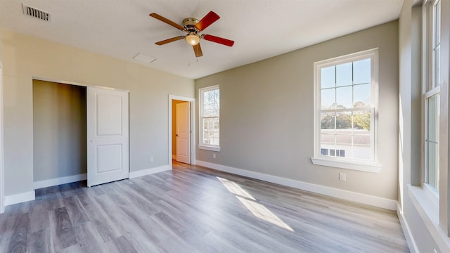 unfurnished bedroom featuring ceiling fan and light hardwood / wood-style flooring