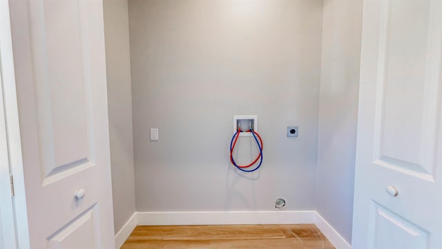 laundry room with hookup for a washing machine, hardwood / wood-style floors, and hookup for an electric dryer