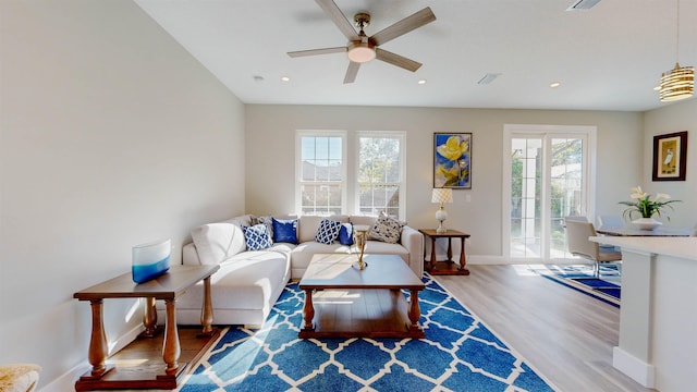 living room featuring ceiling fan and light wood-type flooring