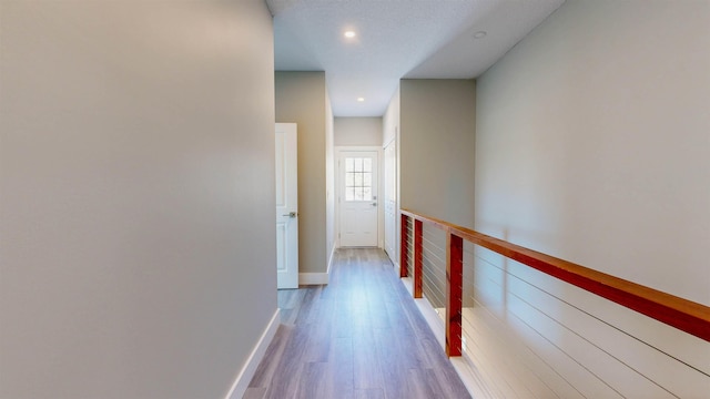 corridor with hardwood / wood-style floors