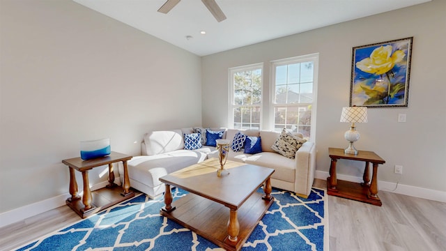 living room with ceiling fan and light hardwood / wood-style floors