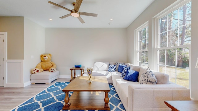 living room featuring ceiling fan and light wood-type flooring