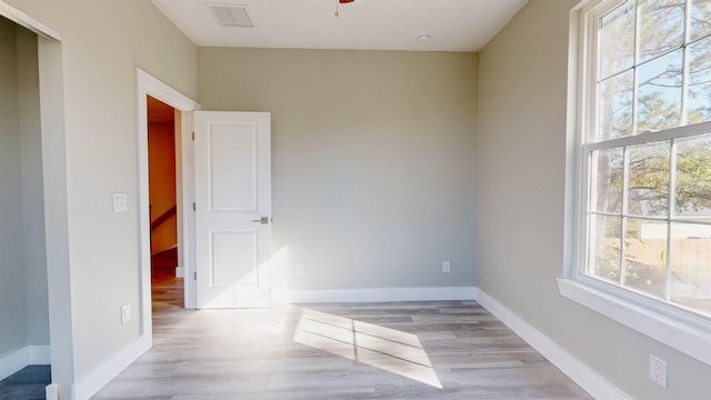 spare room featuring ceiling fan and light wood-type flooring