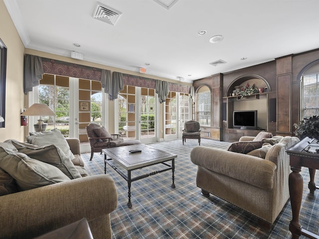 living room featuring ornamental molding, plenty of natural light, and dark carpet