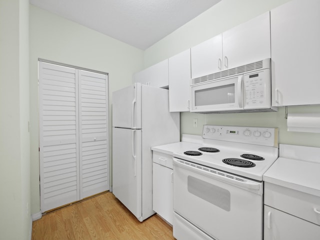 kitchen featuring white cabinetry, white appliances, and light hardwood / wood-style flooring