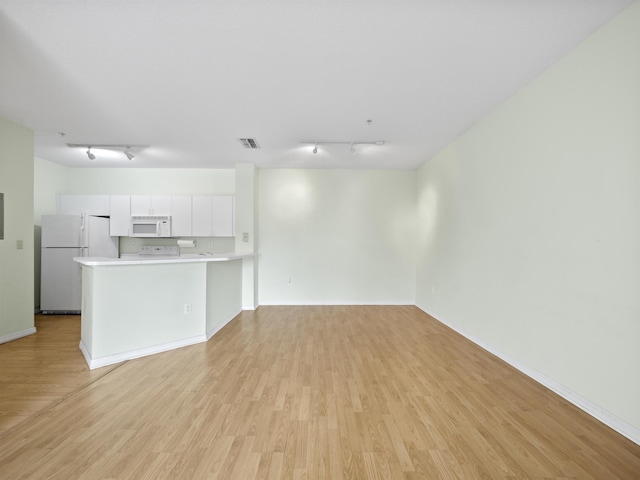 unfurnished living room with light hardwood / wood-style flooring and track lighting