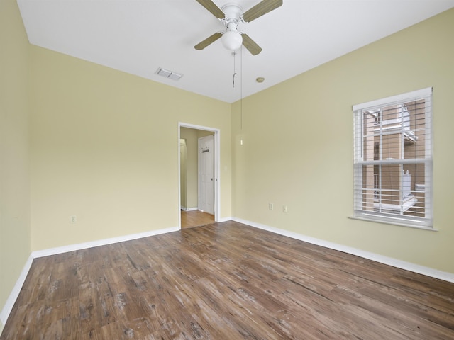 spare room with hardwood / wood-style floors and ceiling fan