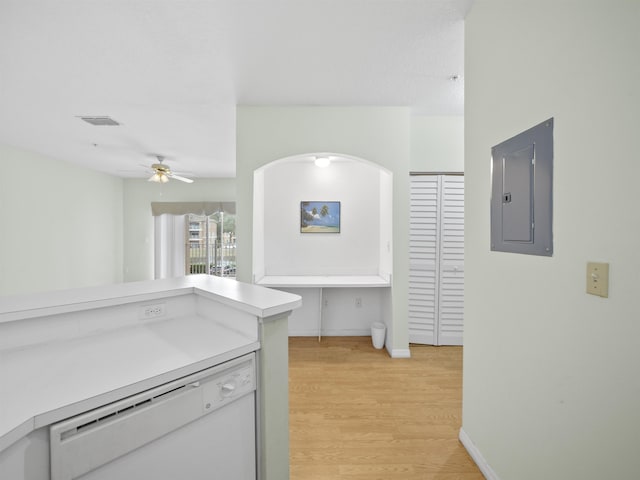 kitchen featuring ceiling fan, electric panel, white dishwasher, and light hardwood / wood-style flooring