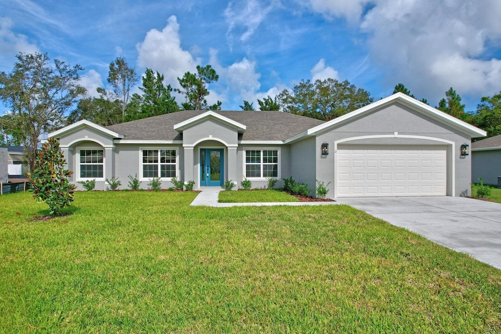 ranch-style home featuring a front lawn and a garage