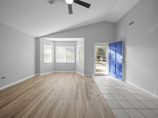 unfurnished living room featuring lofted ceiling, baseboards, visible vents, and wood finished floors