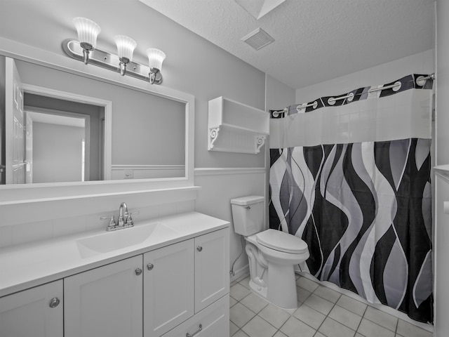 full bath featuring visible vents, toilet, vanity, a textured ceiling, and tile patterned flooring