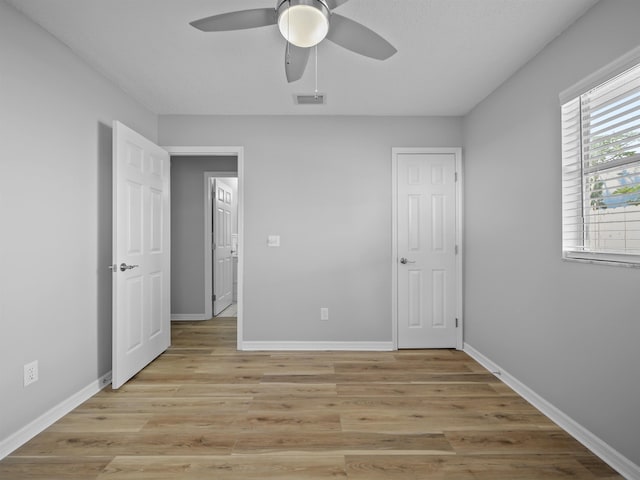 unfurnished bedroom featuring light wood-type flooring, visible vents, and baseboards