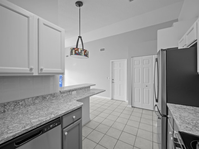 kitchen with light tile patterned floors, tasteful backsplash, visible vents, appliances with stainless steel finishes, and decorative light fixtures