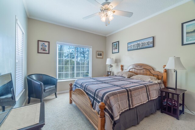 bedroom with ceiling fan, crown molding, and light colored carpet