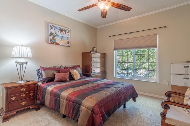 carpeted bedroom with ceiling fan and ornamental molding