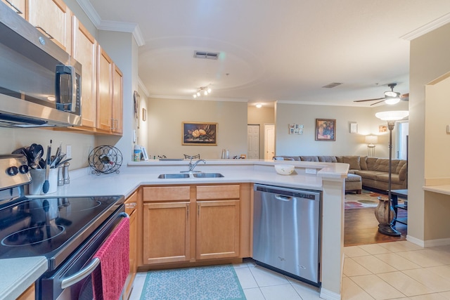 kitchen with stainless steel appliances, sink, light tile patterned floors, kitchen peninsula, and crown molding