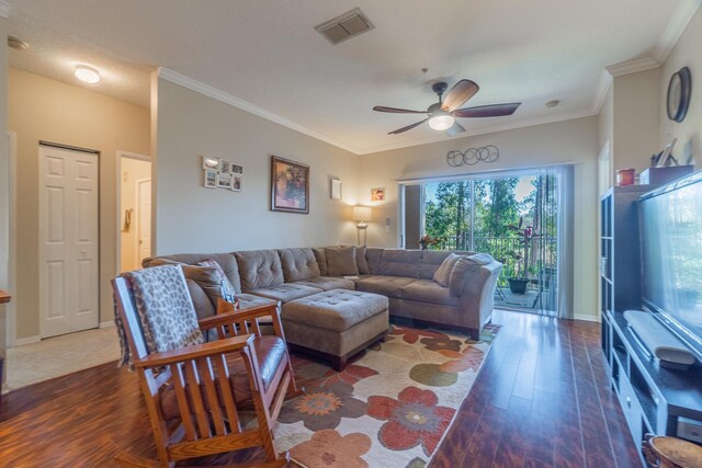 living room featuring ceiling fan, ornamental molding, and dark hardwood / wood-style floors