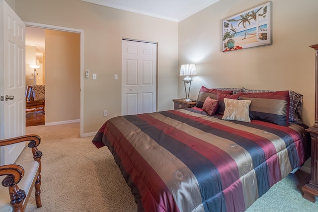 carpeted bedroom featuring a closet and crown molding