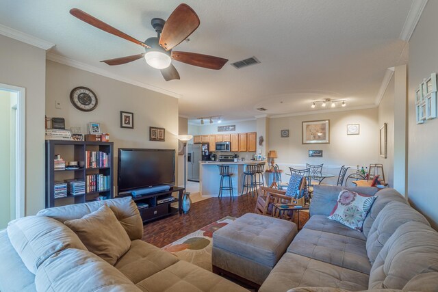 living room featuring rail lighting, ornamental molding, and ceiling fan