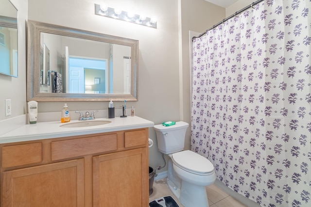 bathroom featuring vanity, tile patterned floors, and toilet