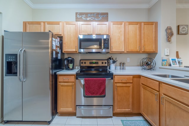 kitchen featuring light brown cabinets, light tile patterned flooring, ornamental molding, and appliances with stainless steel finishes