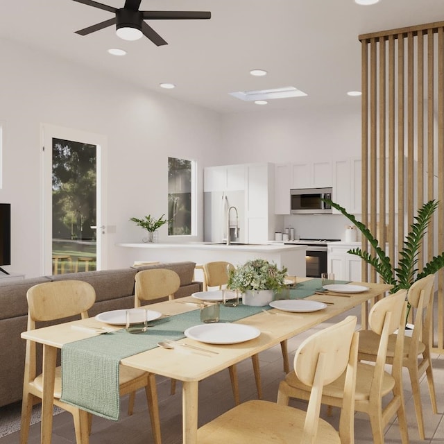 dining room with ceiling fan and sink