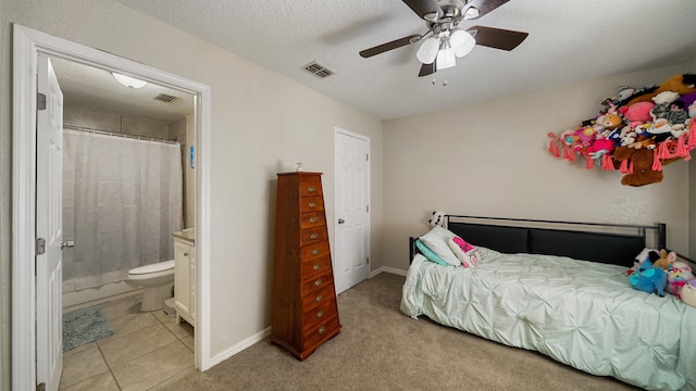 11428 Rustic Pines Cir, Jacksonville, FL 32257 - bedroom featuring ensuite bathroom, baseboards, light tile patterned flooring, and ceiling fan