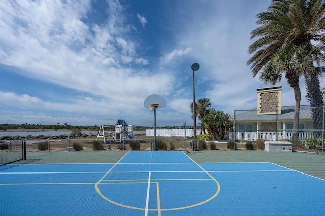 view of basketball court with community basketball court and fence