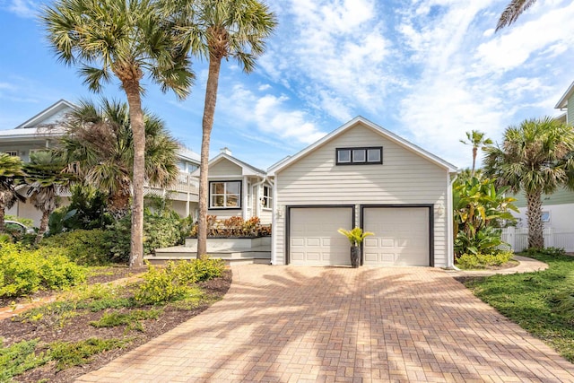 view of front facade with an attached garage and decorative driveway