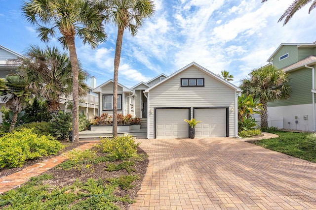 view of front of property with an attached garage and decorative driveway