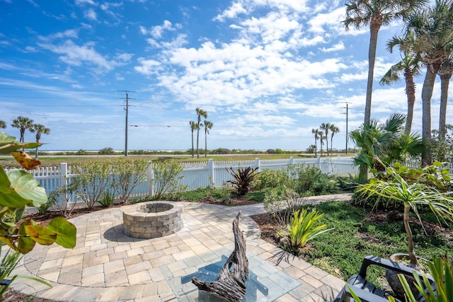 view of patio featuring an outdoor fire pit and fence