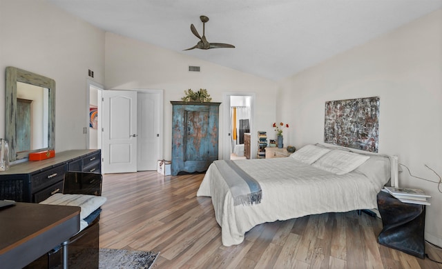 bedroom with visible vents, lofted ceiling, wood finished floors, and a ceiling fan