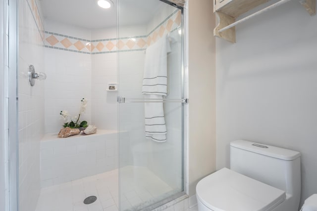 bathroom with toilet and a stall shower