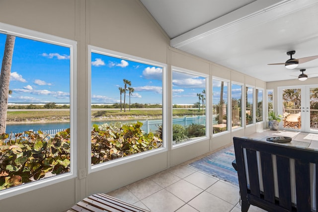 sunroom / solarium with a water view and ceiling fan