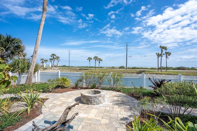 view of patio featuring a fenced backyard and an outdoor fire pit