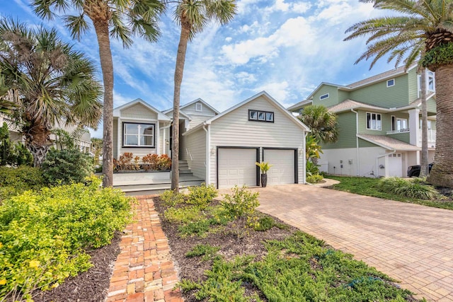 view of front facade with a garage and decorative driveway