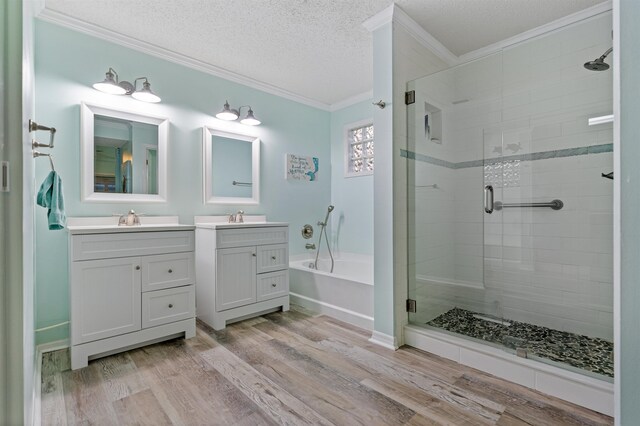 362 Monika Pl, Saint Augustine, FL 32080 - bathroom featuring hardwood / wood-style floors, vanity, ornamental molding, a textured ceiling, and independent shower and bath