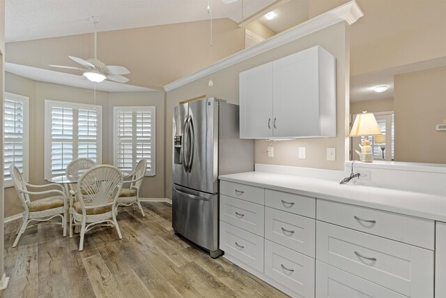 362 Monika Pl, Saint Augustine, FL 32080 - kitchen with vaulted ceiling, white cabinetry, ceiling fan, stainless steel fridge with ice dispenser, and light wood-type flooring