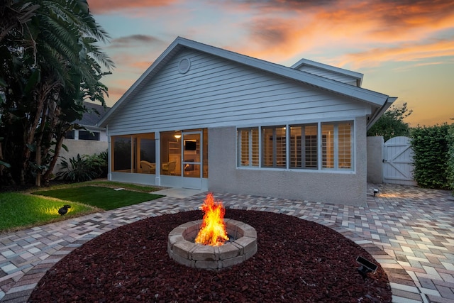 362 Monika Pl, Saint Augustine, FL 32080 - back house at dusk with an outdoor fire pit