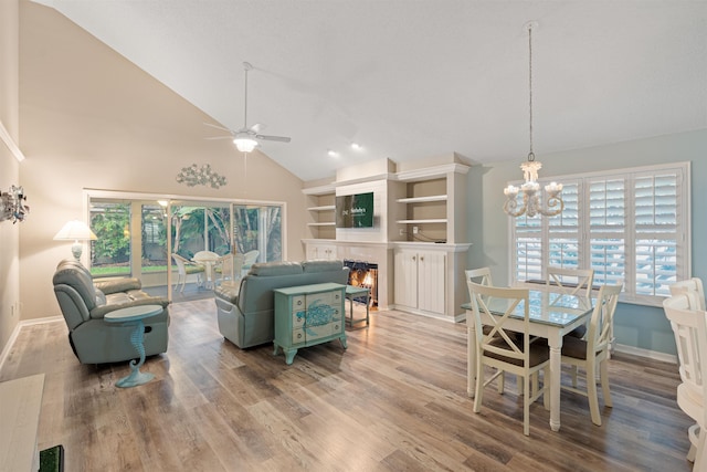 362 Monika Pl, Saint Augustine, FL 32080 - living room featuring ceiling fan with notable chandelier, wood-type flooring, and high vaulted ceiling